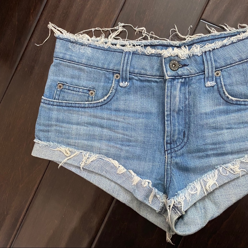 Mid Rise Medium Wash Blue Cheeky Denim Shorts - Picture 2 of 4